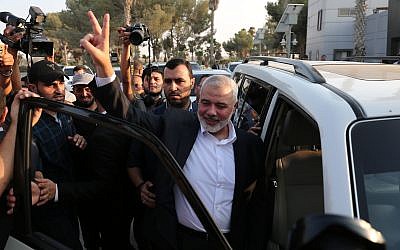 Hamas Chief Ismail Haniyeh flashes the victory gesture upon his arrival at the Rafah border crossing, from Egypt after reconciliation talks with the Fatah movement mediated by Egyptian intelligence, in the southern Gaza Strip, on September 19, 2017. (Abed Rahim Khatib/ Flash90)
