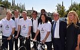 Jerusalem Mayor Nir Barkat (left), Tourism Minister Yariv Levin (on bicycle in middle) and Sports and Culture Minister Miri Regev, with Giro d'Italia organizers and winners celebrating the announcement of the 2018 Giro d'Italia bike race, whose 'Big Start' will take place in Israel in May 2018 (Courtesy 'Big Start')