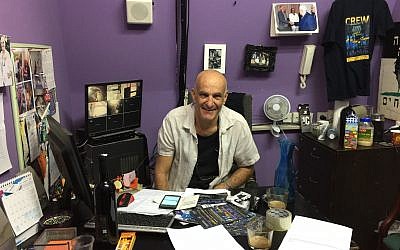 Igal Ezraty, a co-founder of the Jaffa Theater, sitting his theater office on September 10, 2017. (Jessica Steinberg/Times of Israel)