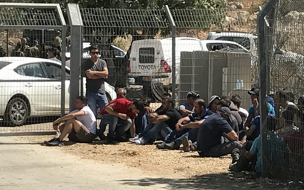 Palestinian laborers sit outside the Har Adar settlement after they were removed from the area by soldiers following a deadly terror attack at the entrance to the community on September 26, 2017. (Jacob Magid/Times of Israel) Palestinian laborers sit outside the Har Adar settlement after they were removed from the area by soldiers following a deadly terror attack at the entrance to the community on September 26, 2017. (Jacob Magid/Times of Israel)