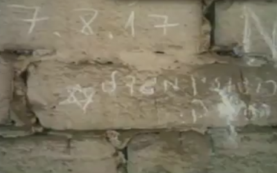 Graffiti bearing the name of Rogozin High School in the northern city of Migdal Haemek that was recently discovered at Auschwitz. (Screen capture: Channel 2)