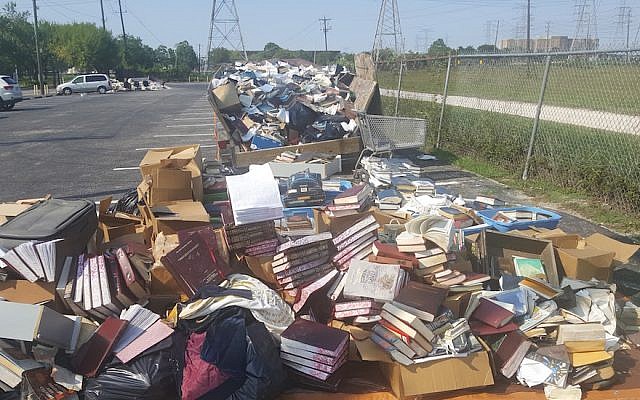 Piles of ruined books from United Orthodox Synagogues of Houston. The congregation lost many of its prayer books and replenished them through donations. (Courtesy of United Orthodox Synagogues via JTA)