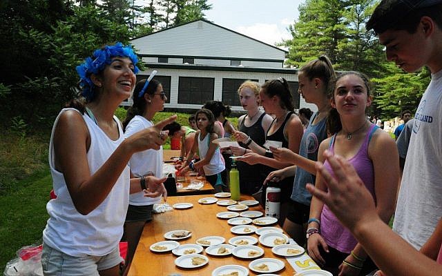 Israeli Staff serve pita and hummus to campers on Israel Day at Camp Tevya in Brookline, New Hampshire. (Amy Blotner/Camp Tevya)