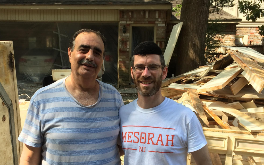 Houston resident Victor Khoury and Rabbi Yehoshua Lewis, director of Mesorah, New Jersey pause during flood recovery efforts. (Courtesy of Lewis) Houston resident Victor Khoury and Rabbi Yehoshua Lewis, director of Mesorah, New Jersey pause during flood recovery efforts. (Courtesy of Lewis)