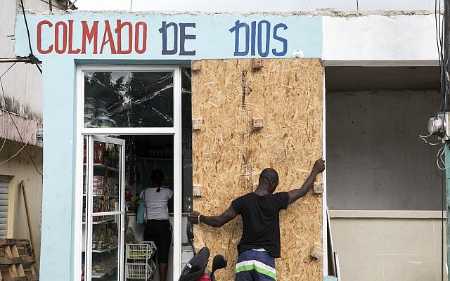 A man covers a bodega's windows before the arrival of Hurricane Irma in Las Terrenas, Dominican Republic, September 6, 2017. (AP Photo/Tatiana Fernandez) A man covers a bodega's windows before the arrival of Hurricane Irma in Las Terrenas, Dominican Republic, September 6, 2017. (AP Photo/Tatiana Fernandez)