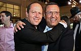 Moshe Lion (R) seen with Jerusalem mayor Nir Barkat, during the wedding of Lion's daughter in Neve Ilan, June 19, 2016. (Yaakov Cohen/Flash90)