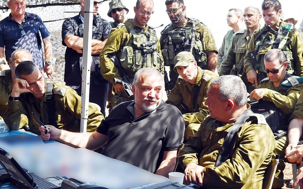Defense Minister Avigdor Liberman, center, speaks with IDF Chief of Staff Gadi Eisenkot, right, as the head of the Northern Command, Maj. Gen. Yoel Strick, right, watches on, during a visit to a large IDF drill in northern Israel on September 12, 2017. (Ariel Hermoni/Defense Ministry)
