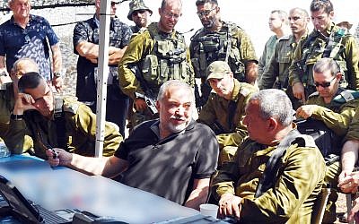 Defense Minister Avigdor Liberman, center, speaks with IDF Chief of Staff Gadi Eisenkot, right, as the head of the Northern Command, Maj. Gen. Yoel Strick, right, watches on, during a visit to a large IDF drill in northern Israel on September 12, 2017. (Ariel Hermoni/Defense Ministry)