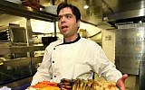 Chef Rafi Cohen, arrested at Ben Gurion Airport on September 7, 2017, seen during better times at his Raphael restaurant in Tel Aviv. (Moshe Shai/FLASh90)