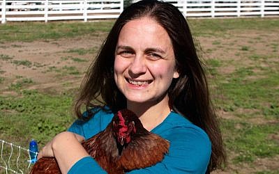 Sarah Chandler leads a twist on the kapparot ritual in which participants hug chickens rather than swinging them over their heads. (Courtesy of Chandler/via JTA)