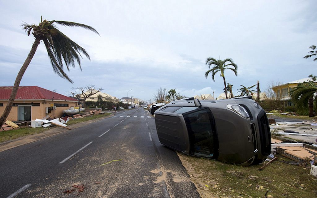 A photo taken on September 6, 2017 shows a car turned onto its side in Marigot, near the Bay of Nettle, on the French side of the Caribbean island of Saint Martin, after the passage of Hurricane Irma. (Lionel Chamoiseau/AFP/Getty Images)
