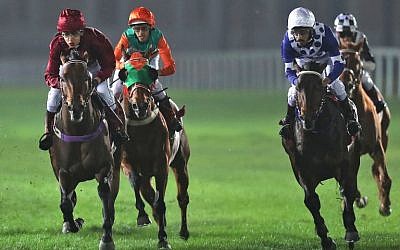 Female Qatari jockey Maryam Al-Subaiey (L) participates in a horse race at the Racing and Equestrian Club in the Qatari capital Doha on February 24, 2017. (AFP Photo/Karim Jafaar)