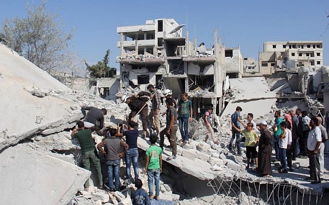 Syrian residents and members of the Syrian Civil Defence, also known as White Helmets, search for victims amid the rubble of a building following a reported overnight airstrike in the rebel-held town of Armanaz, in Idlib province near the Turkish border, September 30, 2017. (AFP/Omar haj kadour) Syrian residents and members of the Syrian Civil Defence, also known as White Helmets, search for victims amid the rubble of a building following a reported overnight airstrike in the rebel-held town of Armanaz, in Idlib province near the Turkish border, September 30, 2017. (AFP/Omar haj kadour)