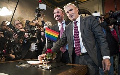 Bode Mende (R) and Karl Kreile stamp their marriage certificate as they become Germany's first gay couple to be legally married, tying the knot at the Schoeneberg town hall in Berlin on October 1, 2017. (Odd Andersen/AFP)