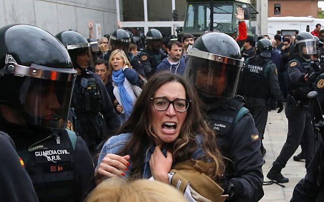 People clash with Spanish Guardia Civil guards outside a polling station in Sant Julia de Ramis, on October 1, 2017, on the day of a referendum on independence for Catalonia banned by Madrid. (AFP PHOTO / Raymond ROIG) People clash with Spanish Guardia Civil guards outside a polling station in Sant Julia de Ramis, on October 1, 2017, on the day of a referendum on independence for Catalonia banned by Madrid. (AFP PHOTO / Raymond ROIG)