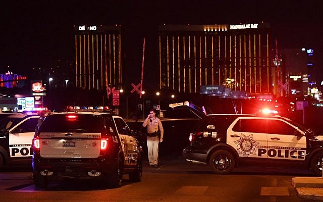 Police form a perimeter around the road leading to the Mandalay Hotel (background) after a gunman killed 58 people and wounded more than 500 others, when he opened fire on a country music concert in Las Vegas, Nevada, October 2, 2017. (AFP/Mark RALSTON) Police form a perimeter around the road leading to the Mandalay Hotel (background) after a gunman killed 58 people and wounded more than 500 others, when he opened fire on a country music concert in Las Vegas, Nevada, October 2, 2017. (AFP/Mark RALSTON)