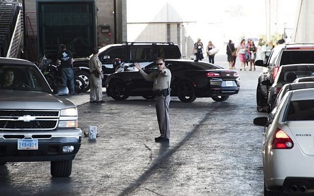 A sheriff's deputy directs cars arriving at the family assistance center at the Las Vegas Convention Center in order to learn more information about their loved ones following a mass shooting, on October 2, 2017. (AFP Photo/Robyn Beck) A sheriff's deputy directs cars arriving at the family assistance center at the Las Vegas Convention Center in order to learn more information about their loved ones following a mass shooting, on October 2, 2017. (AFP Photo/Robyn Beck)