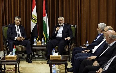 Hamas's overall leader Ismail Haniyeh, right, meets with Egyptian Intelligence Minister Khalid Fawzi at his office in Gaza City on October 3, 2017. (AFP/MAHMUD HAMS)