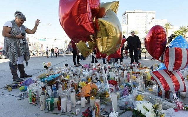 A woman prays at a makeshift memorial on the Las Vegas Strip in Las Vegas, Nevada on October 3, 2017, after a gunman killed 59 people and wounded more than 500 others when he opened fire from a hotel window on a country music festival. (AFP PHOTO / Robyn Beck) A woman prays at a makeshift memorial on the Las Vegas Strip in Las Vegas, Nevada on October 3, 2017, after a gunman killed 59 people and wounded more than 500 others when he opened fire from a hotel window on a country music festival. (AFP PHOTO / Robyn Beck)