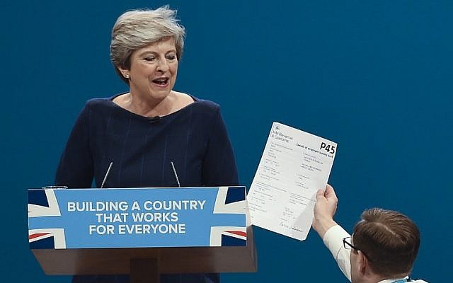 Protester comedian Simon Brodkin (R) gives a piece of paper written as a mock P45 (employee leaving form) to Britain's Prime Minister Theresa May (L) as she delivers a speech on the final day of the Conservative Party annual conference at the Manchester Central Convention Centre in Manchester, England, on October 4, 2017. (AFP Photo/Paul Ellis) Protester comedian Simon Brodkin (R) gives a piece of paper written as a mock P45 (employee leaving form) to Britain's Prime Minister Theresa May (L) as she delivers a speech on the final day of the Conservative Party annual conference at the Manchester Central Convention Centre in Manchester, England, on October 4, 2017. (AFP Photo/Paul Ellis)