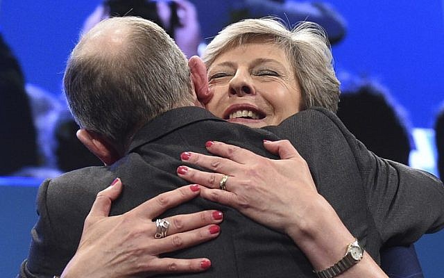 Britain's Prime Minister Theresa May (R) is hugged by her husband Philip May (L) on the stage at the end of her speech on the final day of the Conservative Party annual conference at the Manchester Central Convention Centre in Manchester, northwest England, on October 4, 2017. (AFP PHOTO / Oli SCARFF) Britain's Prime Minister Theresa May (R) is hugged by her husband Philip May (L) on the stage at the end of her speech on the final day of the Conservative Party annual conference at the Manchester Central Convention Centre in Manchester, northwest England, on October 4, 2017. (AFP PHOTO / Oli SCARFF)