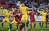 Khaled Almbayed of Syria (2L) and Mathew Leckie of Australia (C) fight for the ball during the 2018 World Cup qualifying soccer match between Syria and Australia at the Hang Jebat Stadium in Malacca on October 5, 2017. (AFP PHOTO/MOHD RASFAN)
