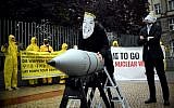 In this picture taken on September 13, 2017, activists of the International campaign to abolish Nuclear Weapons (ICAN) wear masks of US President Donald Trump (R) and North Korea's leader Kim Jong Un as they demonstrate in front of the US embassy in Berlin. (AFP/dpa/Britta Pedersen)