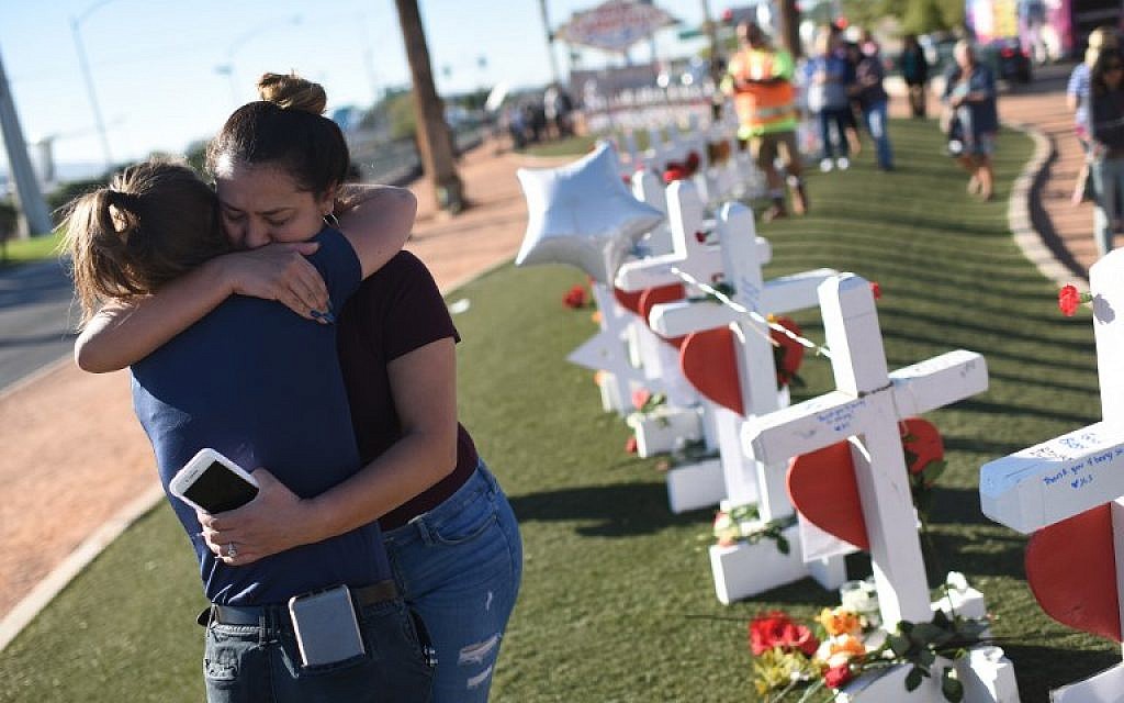 Melissa Gerber, left, and Sandra Serralde, right, comfort each other beside 58 white crosses for the victims of Sunday night's mass shooting on the south end of the Las Vegas Strip, October 6, 2017 in Las Vegas, Nevada. (AFP Photo/Robyn Beck) Melissa Gerber, left, and Sandra Serralde, right, comfort each other beside 58 white crosses for the victims of Sunday night's mass shooting on the south end of the Las Vegas Strip, October 6, 2017 in Las Vegas, Nevada. (AFP Photo/Robyn Beck)