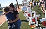 Melissa Gerber, left, and Sandra Serralde, right, comfort each other beside 58 white crosses for the victims of Sunday night's mass shooting on the south end of the Las Vegas Strip, October 6, 2017 in Las Vegas, Nevada. (AFP Photo/Robyn Beck)