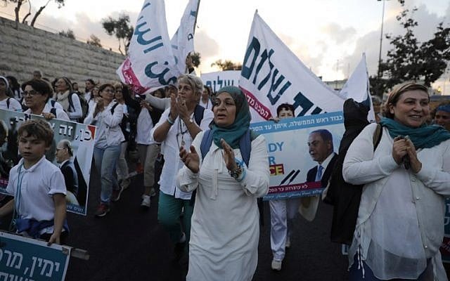 Israeli and Palestinian activists of the Women Wage Peace movement march in the heart of Jerusalem on October 8, 2017. (MENAHEM KAHANA / AFP)