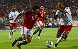 Egypt's Mohamed Salah vies for the ball against Congo's Tobias Badila during their World Cup 2018 Africa qualifying match between Egypt and Congo at the Borg el-Arab stadium in Alexandria on October 8, 2017. (AFP Photo/Tarek Abdel Hamid)