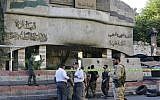 Syrian security forces stand guard outside the main entrance to the police headquarters in Syria's capital Damascus on October 11, 2017, following an attack that targeted the building. (AFP Photo/Louai Beshara)