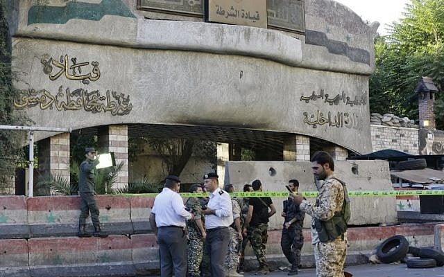 Syrian security forces stand guard outside the main entrance to the police headquarters in Syria's capital Damascus on October 11, 2017, following an attack that targeted the building. (AFP Photo/Louai Beshara) Syrian security forces stand guard outside the main entrance to the police headquarters in Syria's capital Damascus on October 11, 2017, following an attack that targeted the building. (AFP Photo/Louai Beshara)