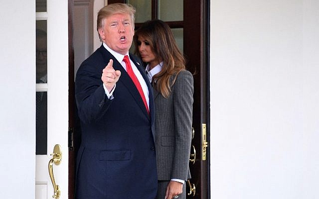 US President Donald Trump (L) answers a question from the press as First Lady Melania Trump walks back into the White House after saying goodbye to the Canadian prime minister and his wife following their Oval Office meeting on October 11, 2017. (AFP Photo/Jim Watson) US President Donald Trump (L) answers a question from the press as First Lady Melania Trump walks back into the White House after saying goodbye to the Canadian prime minister and his wife following their Oval Office meeting on October 11, 2017. (AFP Photo/Jim Watson)