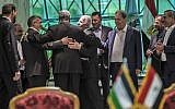 Khaled Fawzi (3rd-L) head of the Egyptian Intelligence services, shares a laugh with Hamas leader Izzat al-Rishq (2nd-L) and Fatah's Azzam al-Ahmad (C) following the signing of a reconciliation deal in Cairo on October 12, 2017. (AFP/Khaled Desouki)