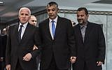 Khaled Fawzi, center, head of the Egyptian Intelligence services, arrives with Fatah's Azzam al-Ahmad, left, and Hamas' Saleh al-Arouri, right, before signing a reconciliation deal in Cairo on October 12, 2017, as the two rival Palestinian movements ended their decade-long split following negotiations overseen by Egypt. (AFP/ KHALED DESOUKI)