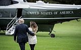 US President Donald Trump and first lady Melania Trump walk to Marine One on the South Lawn of the White House in Washington, DC, on October 13, 2017. Trump earlier on October 13 in a highly-anticipated address refused to certify the 2015 Iranian nuclear deal, and warned the United States may yet walk away from "one of the worst" agreements in history.( AFP PHOTO / Brendan Smialowski)