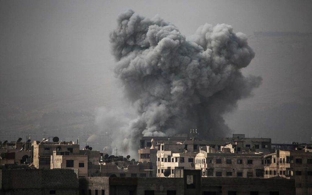 Smoke billows from buildings following a reported air strike on Ain Tarma in the Eastern Ghouta area, a rebel stronghold east of the Syrian capital, on October 16, 2017. (AFP/AMER ALMOHIBANY)