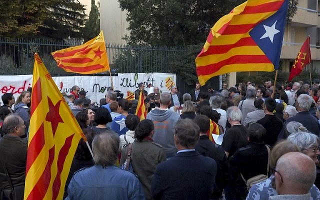 People hold Catalan flags and placards during a protest against the arrest of two Catalan separatist leaders, outside Spain's embassy in Perpignan, on October 17, 2017. (AFP/Raymond Roig) People hold Catalan flags and placards during a protest against the arrest of two Catalan separatist leaders, outside Spain's embassy in Perpignan, on October 17, 2017. (AFP/Raymond Roig)