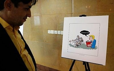 An Iranian man looks at an illustration during the 'Persian Gulf Forever' cartoon exhibition in Tehran on October 18, 2017. (AFP/STR)
