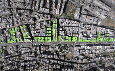 An aerial view of the word "Peace" in Arabic painted on the roofs of 85 buildings in Tripoli's Syria street which separates the Sunni neighborhood of Bab al-Tabbaneh from the Alawite neighborhood of Jabal Mohsen.
The project has been three years in the making, with the artists, 34-year-old twins Mohamed and Omar Kabbani, researching and rejecting multiple locations in their native Lebanon before settling on Tripoli. (AFP PHOTO / ASHEKMAN / Handout)