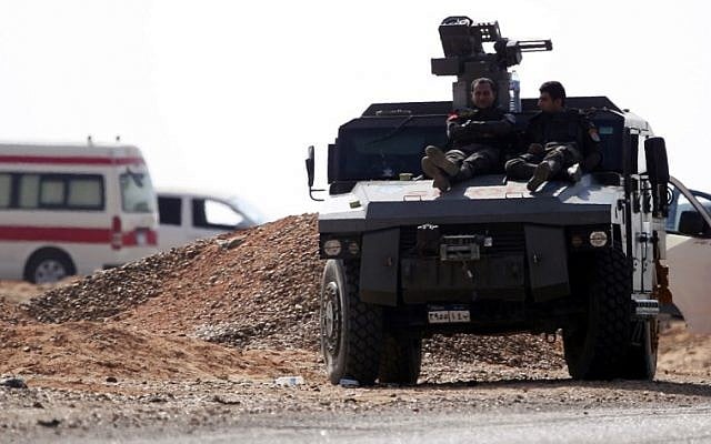 A picture taken on October 21, 2017 shows members of the Egyptian security forces resting on the top of an armoured vehicle (APCs) parked on the desert road leading to the Bahariya oasis in Egypt's western desert, about 135 kilometers (83 miles) southwest of Giza. (AFP Photo/Mohamed El-Shahed) A picture taken on October 21, 2017 shows members of the Egyptian security forces resting on the top of an armoured vehicle (APCs) parked on the desert road leading to the Bahariya oasis in Egypt's western desert, about 135 kilometers (83 miles) southwest of Giza. (AFP Photo/Mohamed El-Shahed)