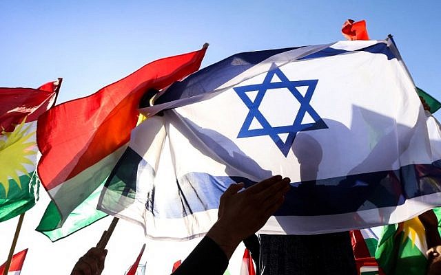 A picture taken on October 21, 2017, shows a man holding an Israeli flag alongside the flag of Iraqi Kurdistan during a demonstration outside the UN Office in Irbil, the capital of the autonomous region. (AFP Photo/Safin Hamed) A picture taken on October 21, 2017, shows a man holding an Israeli flag alongside the flag of Iraqi Kurdistan during a demonstration outside the UN Office in Irbil, the capital of the autonomous region. (AFP Photo/Safin Hamed)
