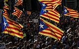 Protesters wave pro-independence Catalan Estelada flags during a demonstration in Barcelona on October 21, 2017. (AFP Photo/ Pau Barrena)