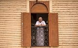 Illustrative: A Moroccan Jewish man looks out his window at the street below from his house in the 'Mellah' Jewish quarter of the Medina in Marrakesh, on October 13, 2017. (AFP PHOTO / FADEL SENNA)