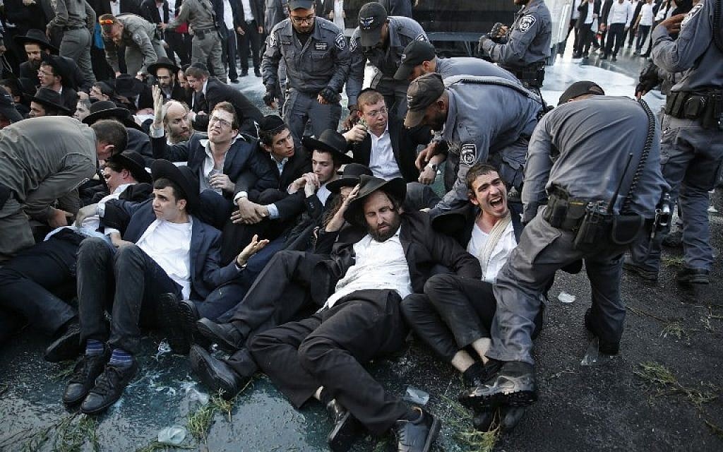 Police spray water to try and disperse a protest by ultra-Orthodox Jews against the conscription of members of their community to the IDF at the entrance to Jerusalem on October 23, 2017. (AFP Photo/Ahmad Gharabli) Police spray water to try and disperse a protest by ultra-Orthodox Jews against the conscription of members of their community to the IDF at the entrance to Jerusalem on October 23, 2017. (AFP Photo/Ahmad Gharabli)