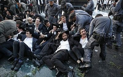 Police spray water to try and disperse a protest by ultra-Orthodox Jews against the conscription of members of their community to the IDF at the entrance to Jerusalem on October 23, 2017. (AFP Photo/Ahmad Gharabli)