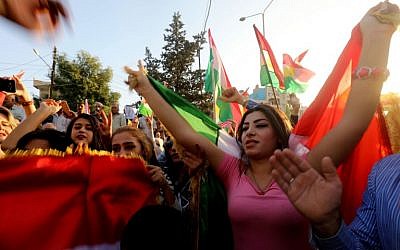 Syrian Kurds demonstrate in the northeastern Syrian city of Qamishli against Iraqi forces operation in the multi-ethnic city of Kirkuk and calling upon the international community to defend Kurdish regions in Iraq, October 23, 2017. (AFP/Delil souleiman)
