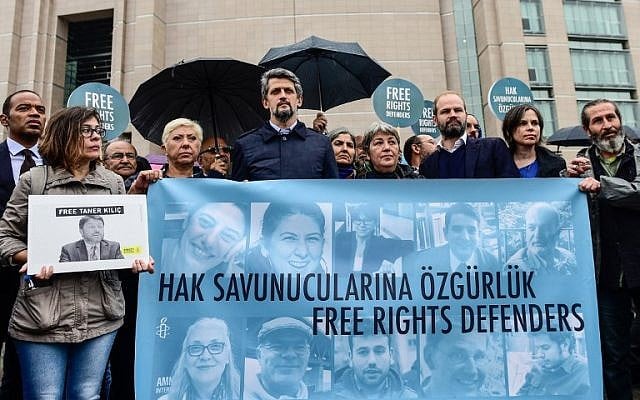 John Dalhuisen Amnesty International's Europe Director (3rd L) joins protesters as they hold a banner that reads, "Free rights defenders" during a rally outside the court house where the trial of eleven human rights activists is taking place in Istanbul, on October 25, 2017. (AFP PHOTO / YASIN AKGUL) John Dalhuisen Amnesty International's Europe Director (3rd L) joins protesters as they hold a banner that reads, "Free rights defenders" during a rally outside the court house where the trial of eleven human rights activists is taking place in Istanbul, on October 25, 2017. (AFP PHOTO / YASIN AKGUL)