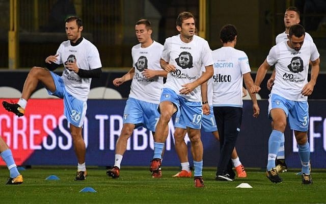 Lazio's players wear t-shirts against antisemitism showing an image of holocaust victim Anne Frank, during the warm up prior the Italian Serie A football match Bologna vs Lazio on October 25, 2017 at the Renato-Dall'Ara stadium in Bologna. AFP Photo/Gianni Schicchi) Lazio's players wear t-shirts against antisemitism showing an image of holocaust victim Anne Frank, during the warm up prior the Italian Serie A football match Bologna vs Lazio on October 25, 2017 at the Renato-Dall'Ara stadium in Bologna. AFP Photo/Gianni Schicchi)